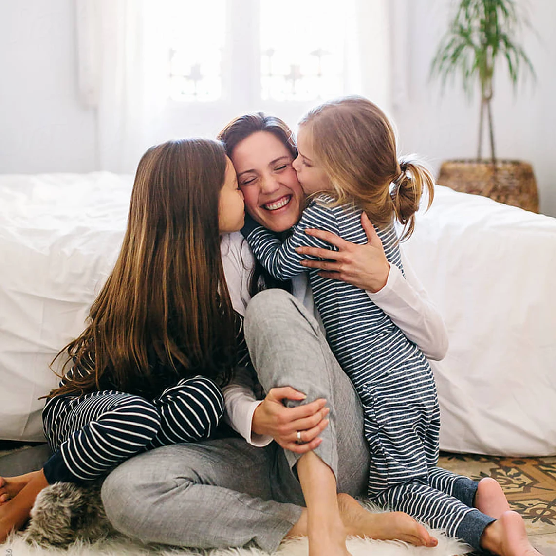 Daughters Kissing Moms Cheeks