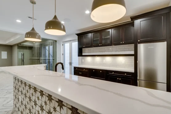 Long kitchen island in Multi Generational Home Plan, The Madison by Classic Cottages.