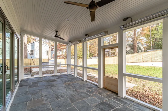 Covered, screen-in porch at Multi Generational Home Plan, The Madison by Classic Cottages.