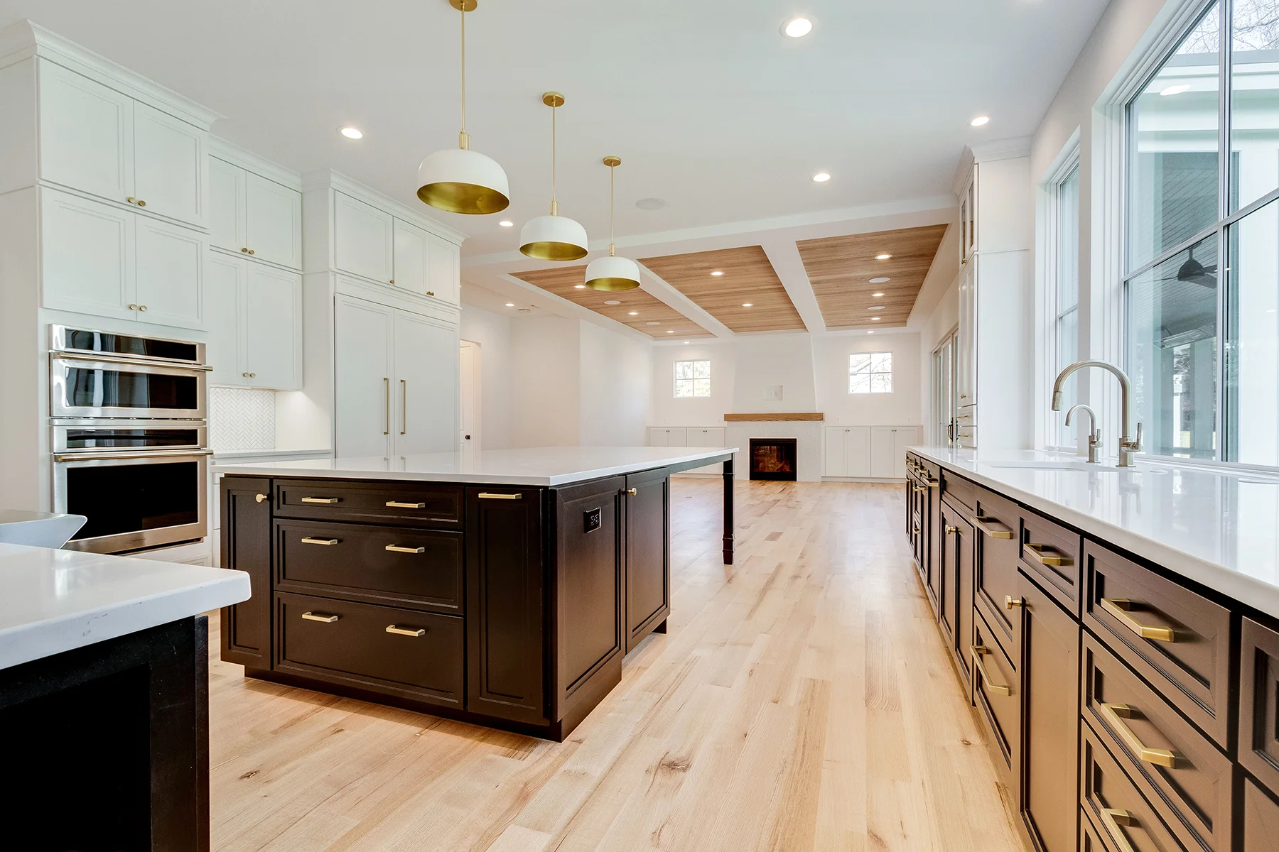 Large open concept kitchen and living area in Multi Generational Home Plan, The Madison by Classic Cottages.