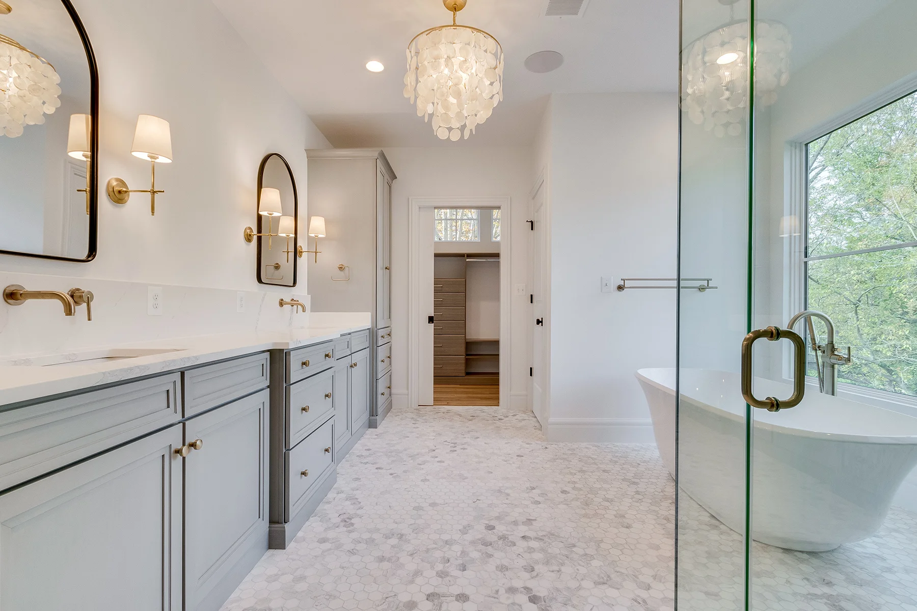 Primary bathroom sinks and closet in Multi Generational Home Plan, The Madison by Classic Cottages.