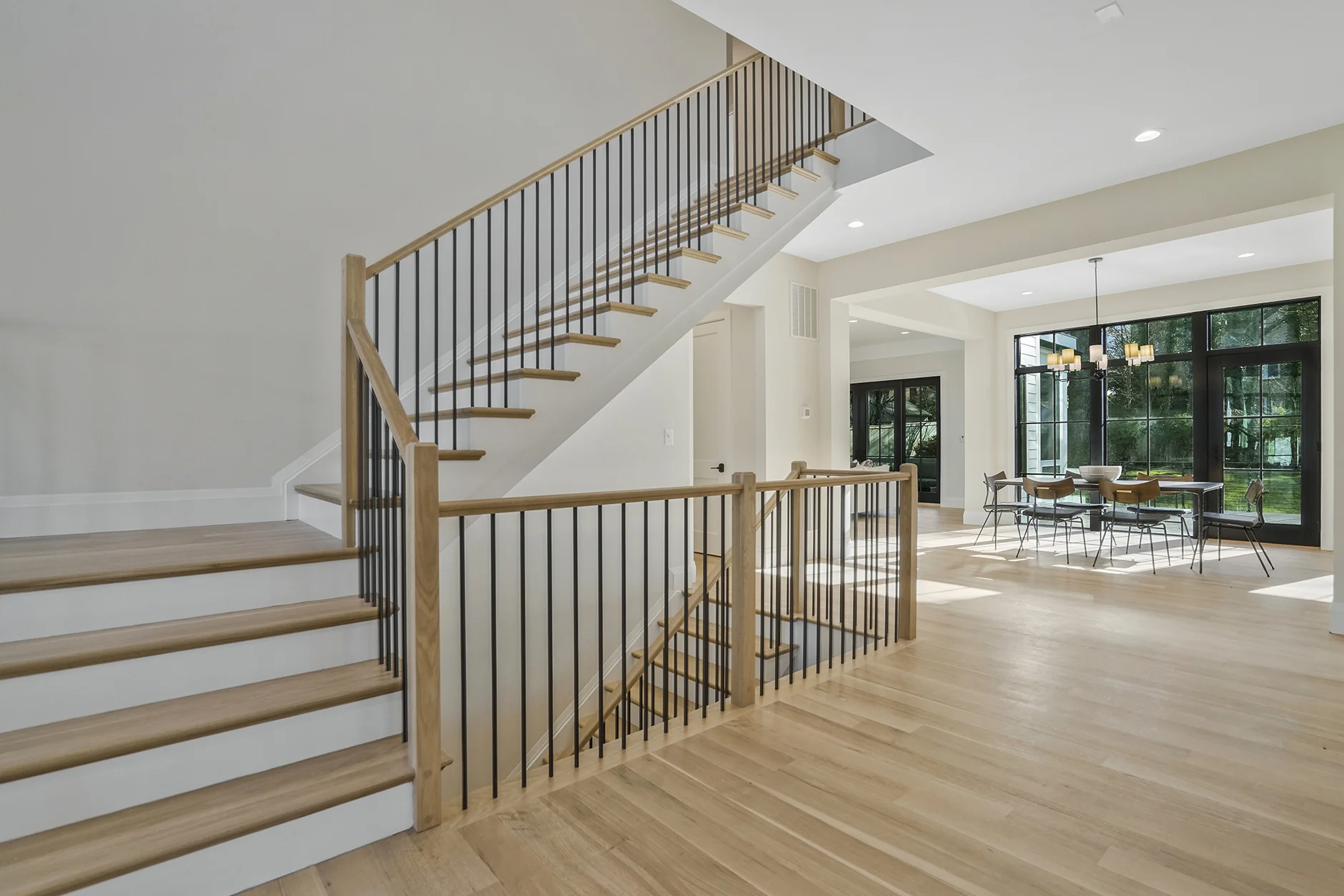 The Cali Stairs and entry way in a new construction luxury home by homebuilder Classic Cottages